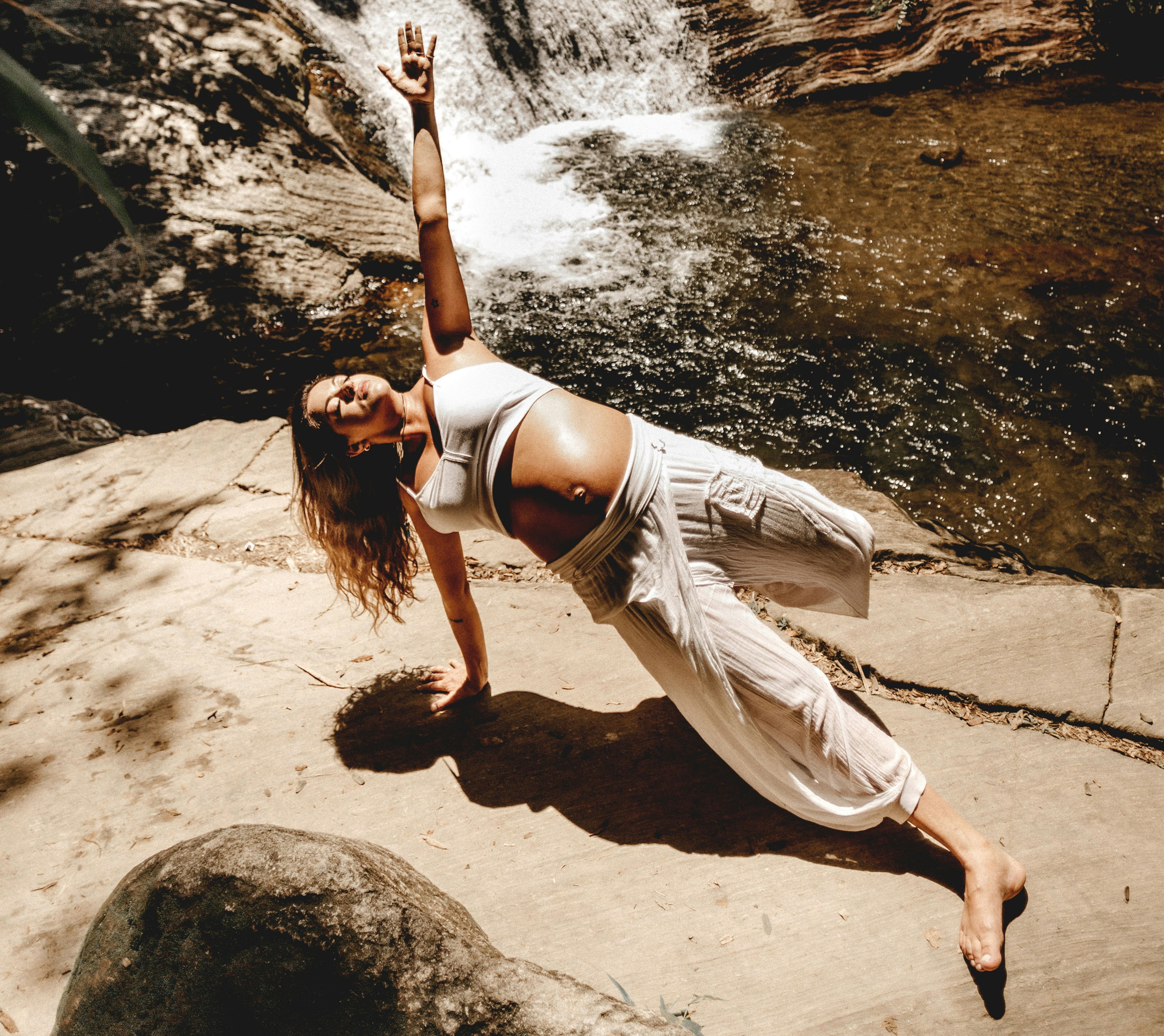 A pregnant woman doing yoga in the sun